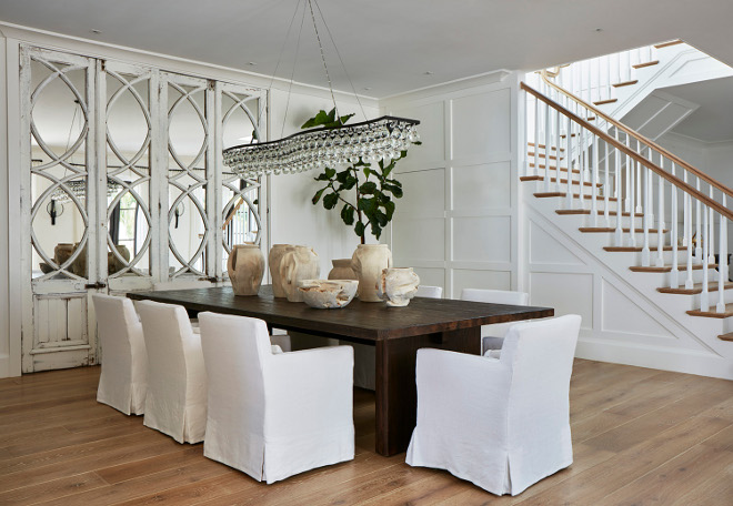 Coastal farmhouse dining room. Coastal farmhouse dining room design. The focal point of this farmhouse dining room is created by adding distressed mirrored doors to a built-in hutch. Coastal farmhouse dining room. Coastal farmhouse dining room #Coastalfarmhousediningroom #farmhousediningroom #farmhouse #diningroom Pineapples Palms, Etc