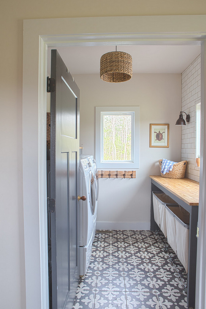 Farmhouse laundry room with grey interior door, grey custom folding doors and cement floor tile. Grey interior door paint color is Blackened by Farrow and Ball #BlackenedbyFarrowandBall Sharon Barrett Interiors