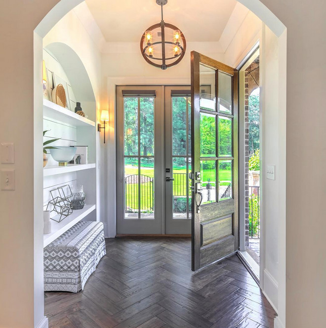 Foyer Design. Foyer with herringbone hardwood floors and arched nook with shiplap and shelves. Foyer. Foyer design #foyer #foyerdesign #herringbonehardwoodfloors #hardwoodfloors #archednook #nook #shiplapnook #shiplap Via Beacham & Company