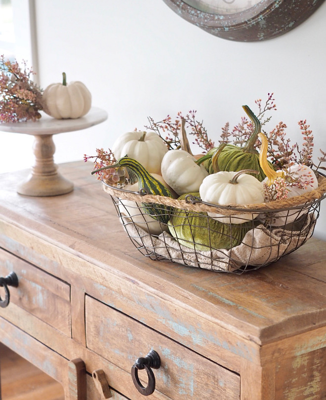 Metal basket with faux white pumpkins and velvet pumpkins, squash and greenery. Farmhouse Fall decor #fall #falldecor #farmhousefall #farmhousefalldecor #velvetpumpkins #whitepumpkins #greenery @WowILoveThat