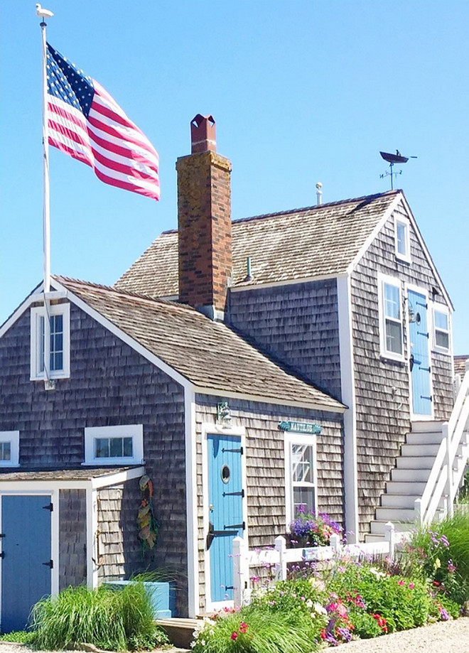 Nantucket Shingle Cottage with blue front door and blue shutters. Via glimpse guides