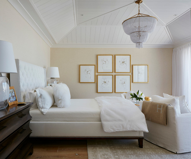 Neutral master bedroom. Neutral master bedroom with gilded art frames, white bedding, white beaded chandelier and white shiplap tray ceiling #masterbedroom #neutralbedroom #whitebedding #trayceiling #shiplaptrayceiling #artframes Pineapples Palms, Etc