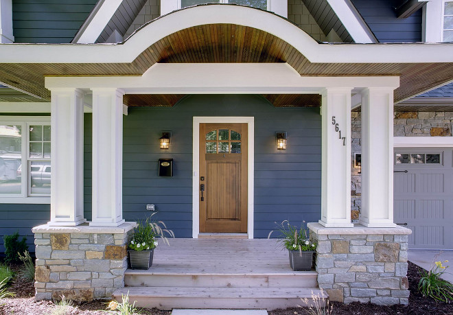 Wooded front door is by Simpsons Doors. Porch: cedar wood decking (for the deck). Hem fir for the ceiling (with a dark stain). Cedar and Miratek for the columns. Sicora Design/Build