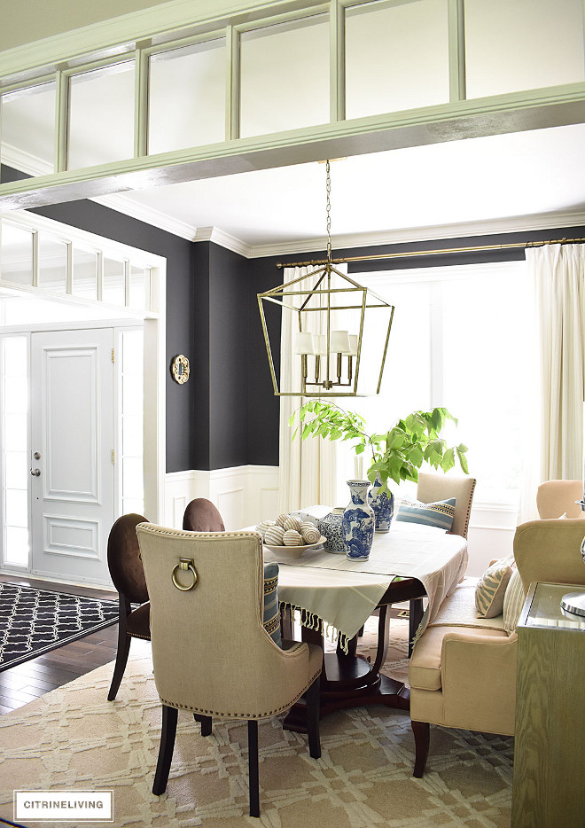 dining-room-with-transoms-black-walls-upholstered-nailhead-trim-chair-with-brass-ring-pull-white-custom-drapery-tonic-living Beautiful Homes of Instagram @citrineliving Home Bunch