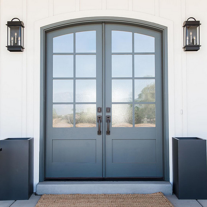 Arched front door is solid wood painted in Farrow and Ball Down Pipe. Millhaven Homes