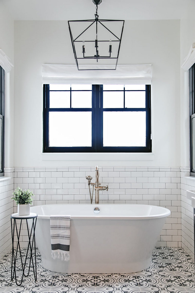 Farmhouse bathroom tub ideas. Farmhouse bathroom with freestanding tub, white subway tile walls, black and white patterned tiles and black steel windows. #bathroom #farmhousebathrooms #blacksteelwindow #patternedtile #subwaytile #walltile Sita Montgomery Interiors