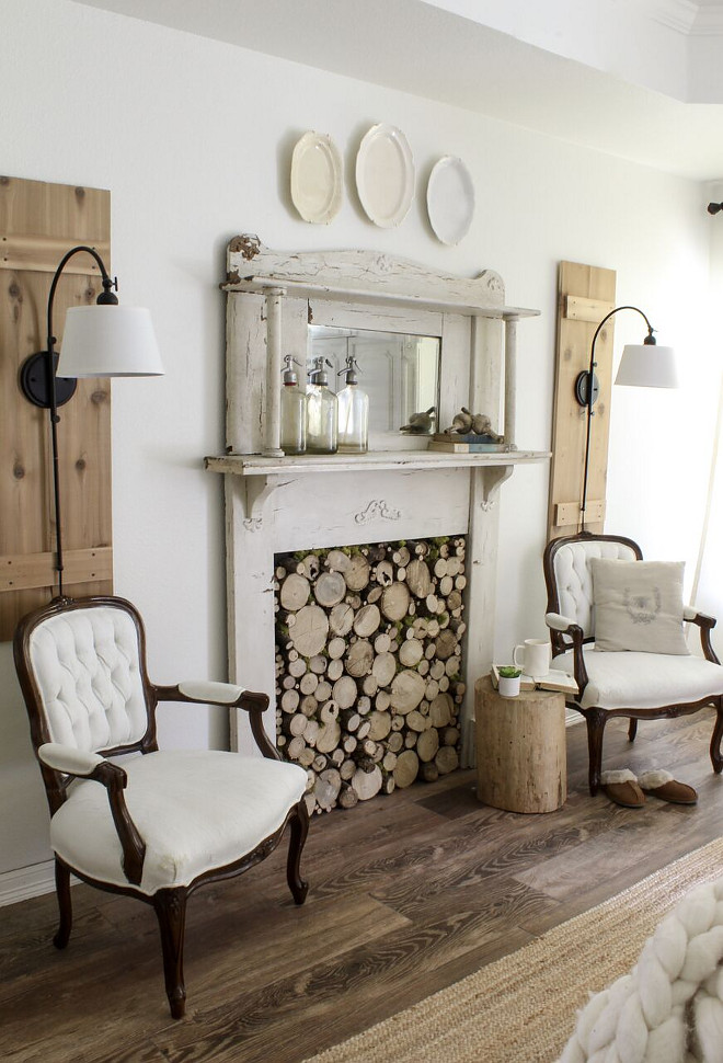 Fireplace early 1900’s vintage mantel w DIY wood slice insert and antique French chairs. Home Bunch Beautiful Homes of Instagram @cottonstem