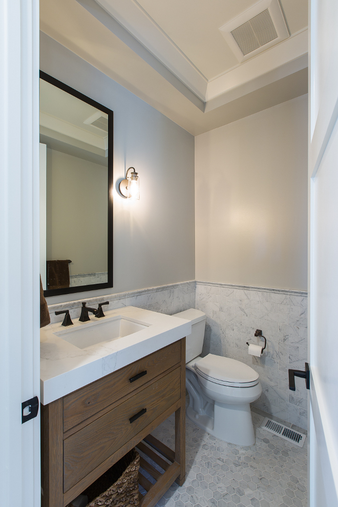 Modern Farmhouse Bathroom with white oak vanity with chunky white quartz countertop, marble subway tile wainscotting and hex floor tile. Paint colors is "Sherwin Williams Repose Gray". Modern Farmhouse Bathroom with white oak vanity with chunky white quartz countertop, marble subway tile wainscotting and hex floor tile. Modern Farmhouse Bathroom with white oak vanity with chunky white quartz countertop, marble subway tile wainscotting and hex floor tile. Modern Farmhouse Bathroom with white oak vanity with chunky white quartz countertop, marble subway tile wainscotting and hex floor tile #ModernFarmhouseBathroom #FarmhouseBathroom #whiteoakvanity #chunkywhitequartzcountertop #chunkycountertop #whitequartzcountertop #marblesubwaytile#marblesubwaytilewainscotting #tilewainscotting #hexfloortile AK Construction