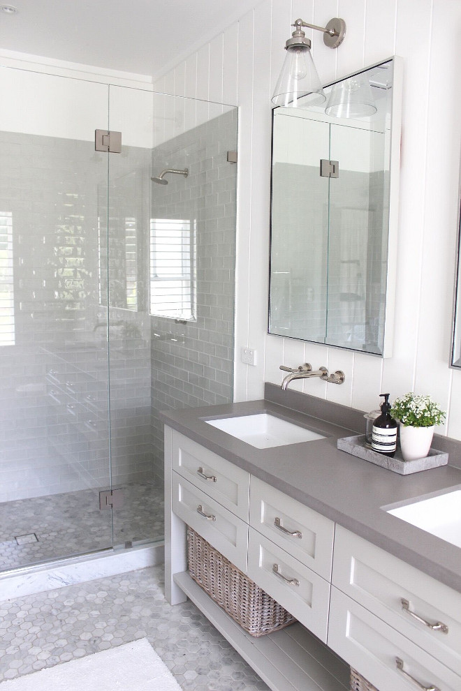 Modern farmhouse bathroom. Neutral Modern farmhouse bathroom. Modern farmhouse bathroom with vertical shiplap, grey quartz countertop, grey shower tile and hex marble floor tile #modernfarmhousebathroom #farmhousebathroom Beautiful Homes of Instagram @urban_farmhouse_build