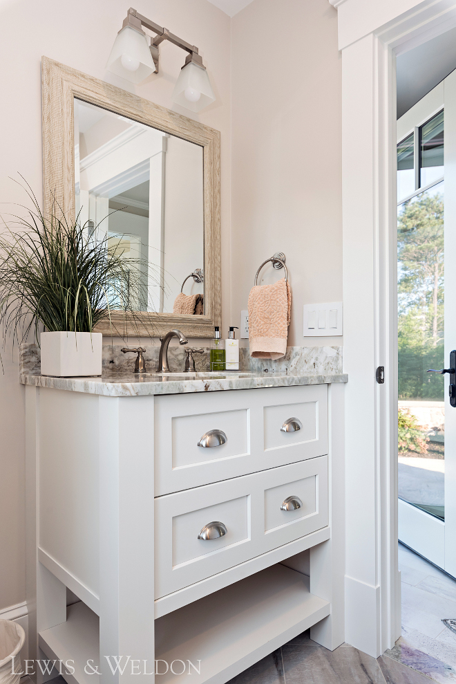 Small bathroom vanity design Custom cabinetry with recessed panel, beveled inside edge detail- Maple painted Benjamin Moore PM-2 White. Wall paint color is Benjamin Moore, OC-13 Soft Chamois. Countertop is Fantasia Brown Granite. #smallvanity #bathroom #customvanity #vanity #fantasiabrowngranite Lewis & Weldon Custom Kitchens