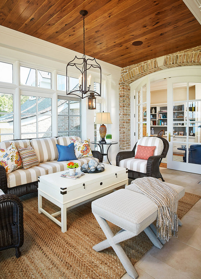 Sunroom furniture and decor. Sunroom tongue and groove ceiling. Sunroom lighting. Sunroom arched brick accent wall. Sunroom Limestone floor tile #sunroom Mike Schaap Builders