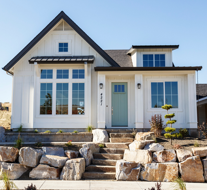 White exterior siding with turquoise front door. Turquoise front door paint color Benjamin Moore Wythe Blue HC-143. Benjamin Moore Wythe Blue HC-143. Board and batten siding is Benjamin Moore White Dove OC-17. #BenjaminMooreWytheBlueHC143