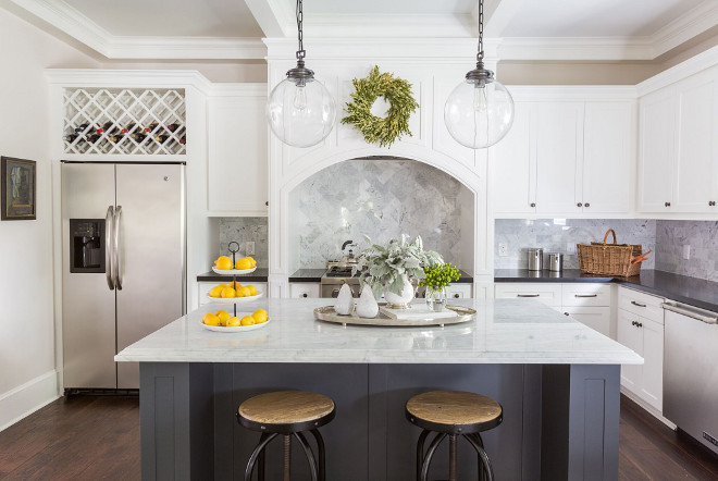 White kitchen with dark grey island, white marble island countertop and black granite perimeter countertop. #kitchen #whitekitchen #darkgreyisland #whitemarble #blackgranite Marie Flanigan Interiors