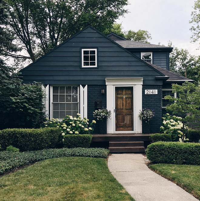Home Exterior. This small home is a good example that you don't always need to renovate your exterior. Use a trendy yet neutral color like this navy blue, accentuate with thick white trim and give your landscaping some attention. Curb appeal without breaking the bank!
