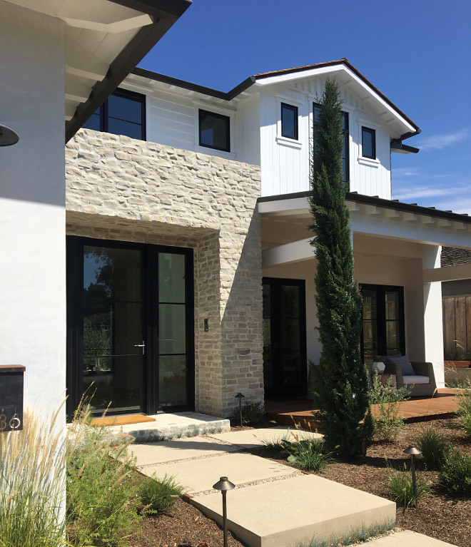 Black Windows Modern Farmhouse exterior with black windows and black steel and glass front door, This stunning steel framed entry and sliding panel door system are La Cantina, Black Windows Modern Farmhouse exterior #BlackWindows #ModernFarmhouseexterior