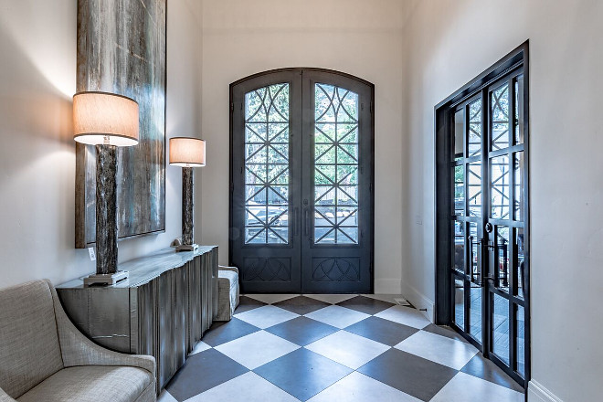 Custom Wrought Iron and Glass front door. The front door measures 11′ x 7′ and it is by Iron Door Works. Tree Haven Homes & Danielle Loryn Design