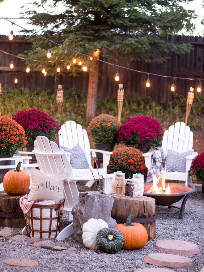 Fall Backyard Decor ideas. Backyard decorated for Fall with many mums, pumpkins, adirondack chairs and outdoor string lights. Fall Backyard @idreamofhomemaking