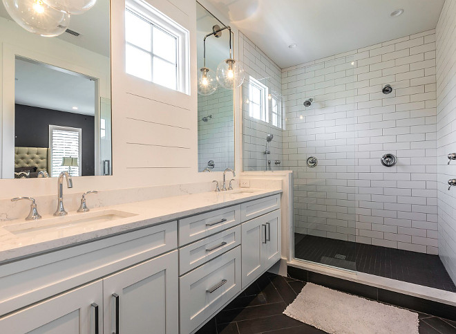 Famrhouse Bathroom with white subway tile walls and black herringbone floor tile Farmhouse bathroom with shiplap,white subway tile walls and black herringbone floor tile