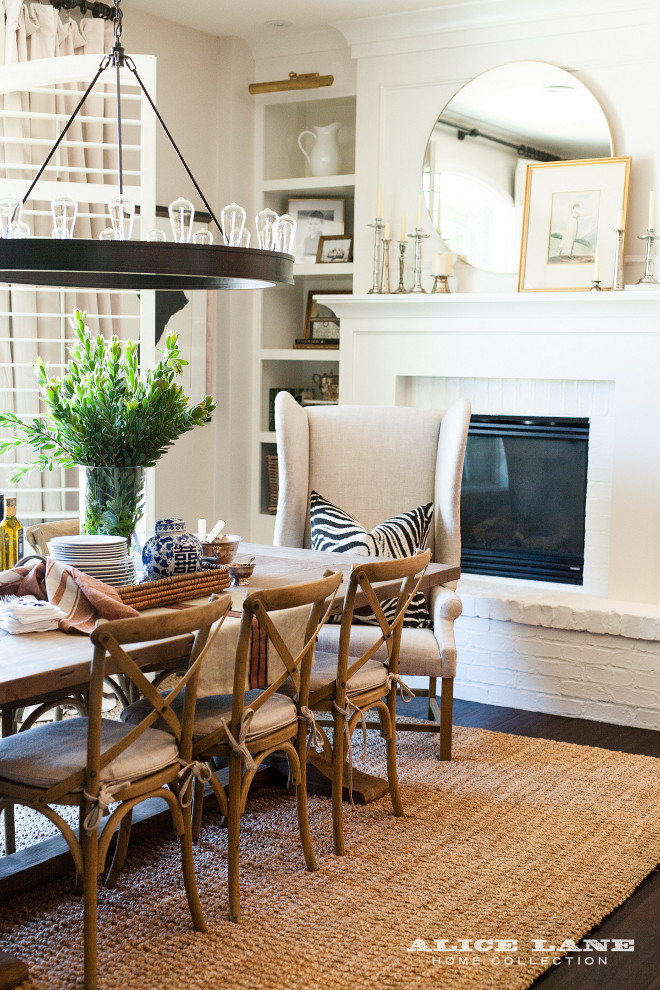 Farmhouse Breakfast Nook. Layered Farmhouse Breakfast Nook with sisal rug, wingback dining chair, trestle table and industrial chandelier. Farmhouse Breakfast Nook #Farmhouse #BreakfastNook Alice Lane Home Collection