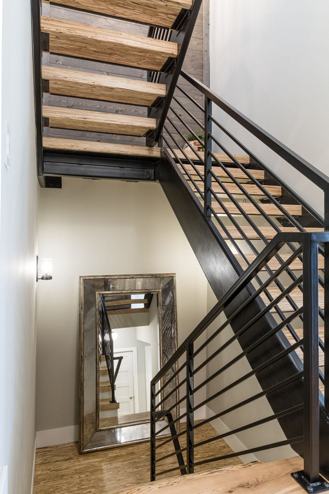 Industrial Modern Farmhouse Metal and reclaimed wood Staircase Paralam stairs with custom metal handrail and barnwood covered feature wall