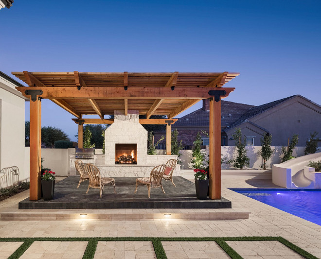 Pergola with black slate tile and stone fireplace. A Finer Touch Construction