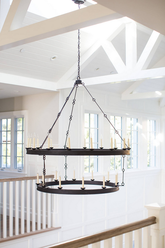 Chandelier Two tiers of flattened iron bands form rings that hang from slender linked chains to make this a powerful 30-light fixture in spaces with high ceilings