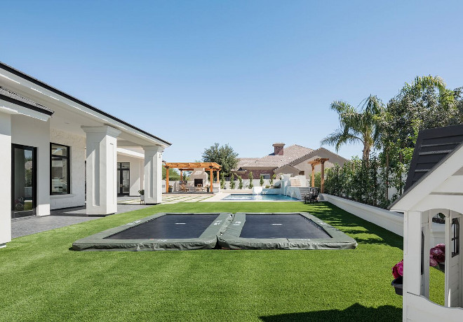 Underground trampoline. Backyard with underground trampoline. The patio doors open to an expansive backyard with two underground trampolines, playhouse and a pool area. #undergroundtrampoline A Finer Touch Construction