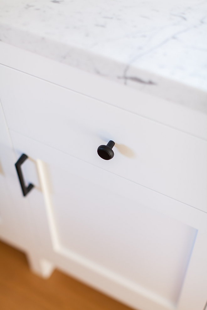 White kitchen cabinet with black hardware