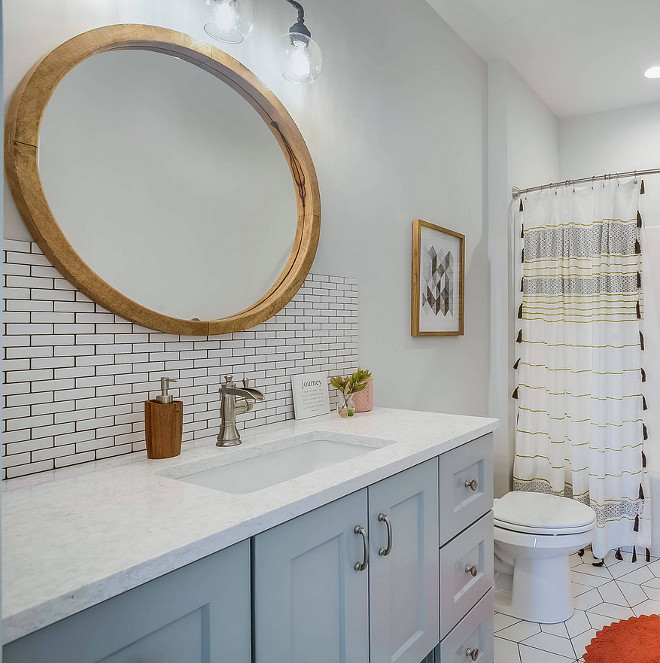 Farmhouse Kids Bathroom with light blue vanity, mini subway tile and reclaimed wood round mirror Farmhouse kids bathroom #farmhousebathroom #kidsbathroom