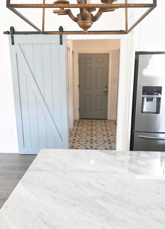 Grey Barn Door A grey barn door conceals a modern farmhouse-inspired mudroom #greybarndoor #mudroom Home Bunch Beautiful Homes of Instagram