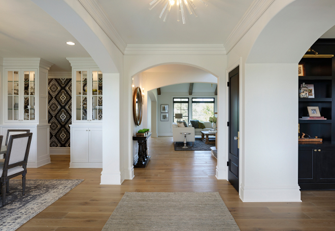 The front door opens to wide foyer with arches and hardwood floors A home office is located on the right and the formal dining room is located on the left