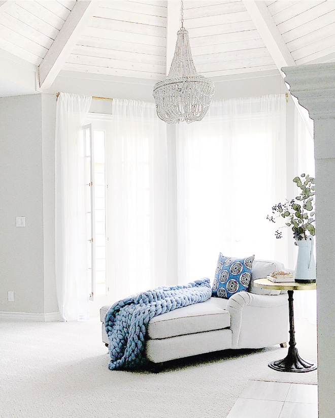 Bedroom sitting area with shiplap and beam ceiling