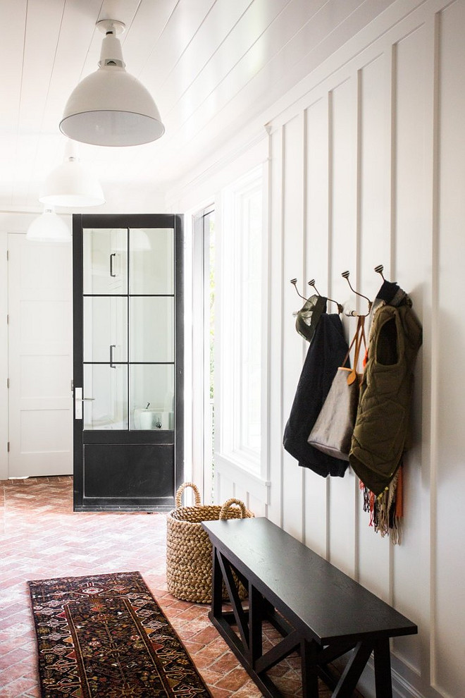 Board and batten entry with herringbone brick flooring