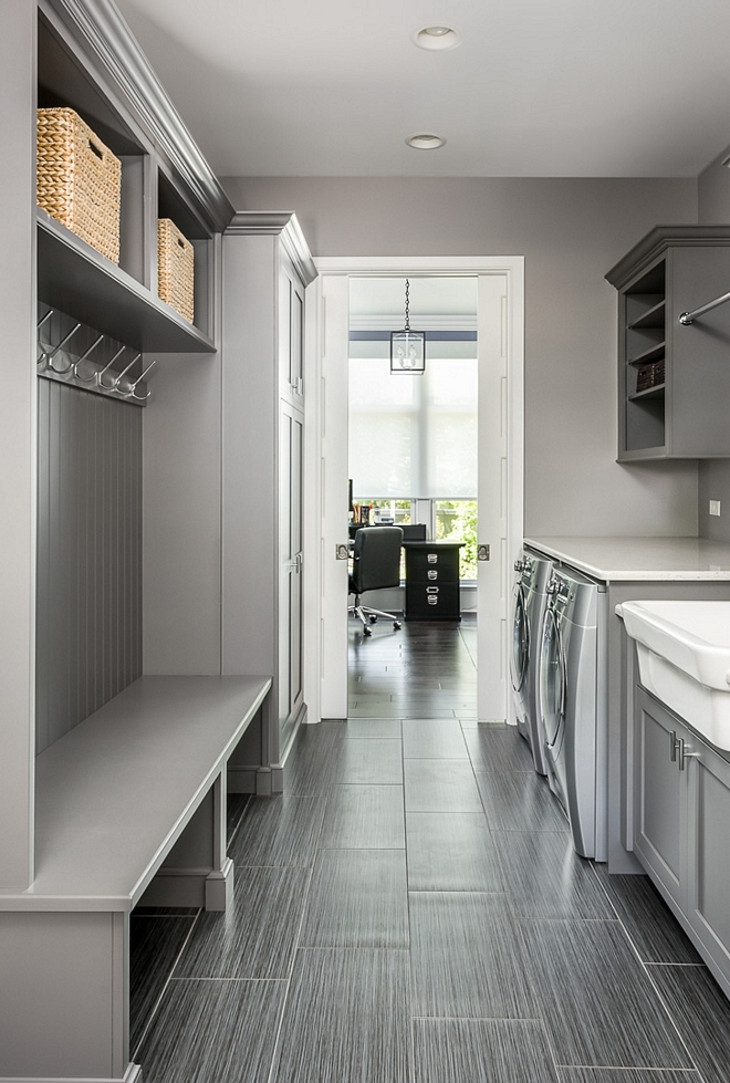 This grey mudroom/laundry room is so practical and the tile is really low-maintenance, which is a must in this space grey mudroom