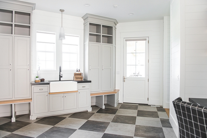 The main floor laundry room/mudroom includes a farm sink with splash guard, floor cubbies, storage lockers, study desk and double fridge/freezer