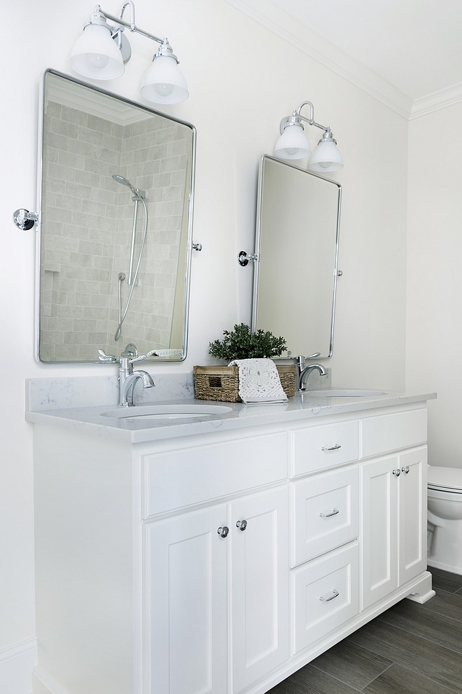 Bathroom features a vanity with two sinks and hardwood-looking floor tile
