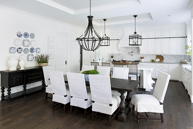 Blue and white dining room opens to white kitchen striped slipcovered dining chairs Kitchen and dining room features inset ceiling with shiplap