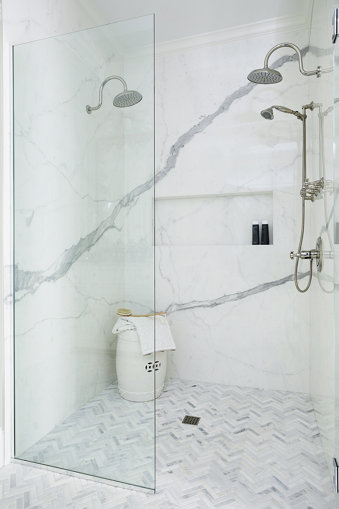 Curbless shower This curb-less shower features porcelain tile panels and marble herringbone floor tile