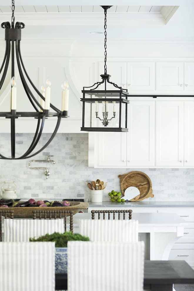 White kitchen and dining room lighting White cabinetry beautifully contrasts with the bronze light fixtures