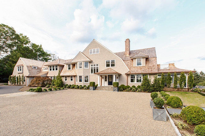 Classic shingle home with gravel driveway Shingles are Waska White Cedar Shingles, 5" exposure factory finish - coat weathering stain