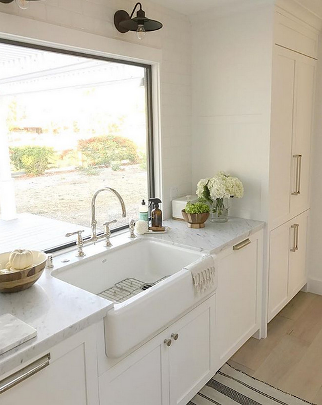 Kitchen Farmhouse Sink and barn sconce above sink