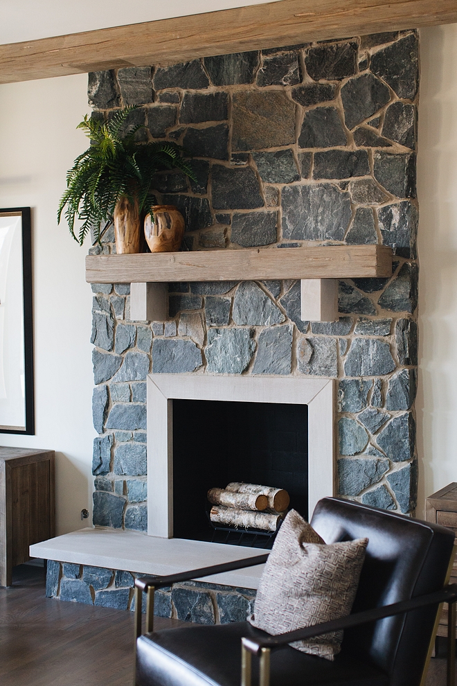 Farmhouse Fireplace The fireplace features a grey natural stone and rustic beam mantel Farmhouse fireplace