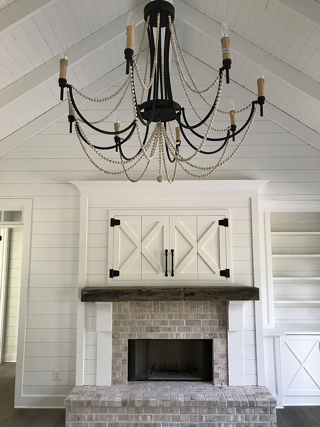 Fireplace Farmhouse Fireplace Brick Fireplace with Beam over Fireplace Antique Railroad Tie Shiplap and hidden TV with Barn style doors