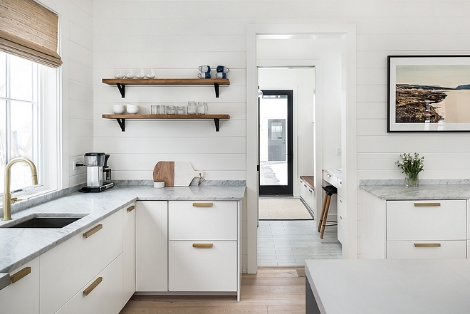 Modern farmhouse kitchens Perimeter countertop is Carrera marble Backplash is shiplap painted in Benjamin Moore Simply White