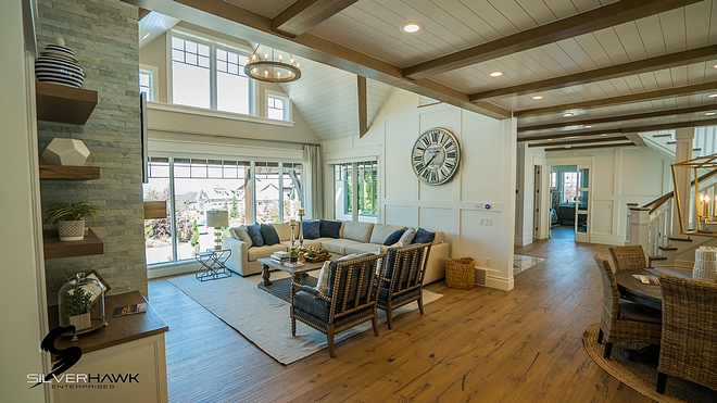 Living Room The living room features a tall stone fireplace flanked by built-ins with White Oak floating shelves Living room