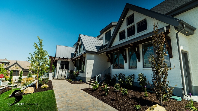 Timber Pergola over porch and wood Accent corbels: Dark Walnut stain by Sherwin Williams