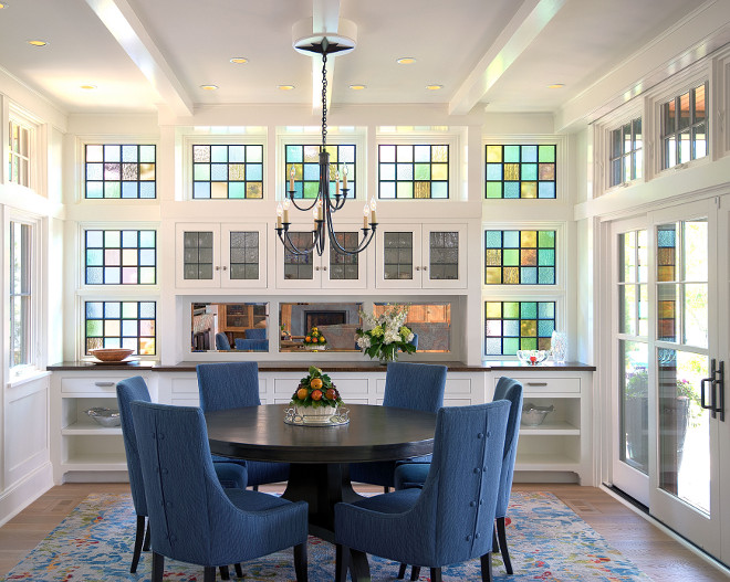 Dining Room with leaded-glass window Subtle nods to the nautical are found throughout the home — including in this leaded-glass window wall The art glass both screens a neighbor ’s house from view and glows in afternoon light