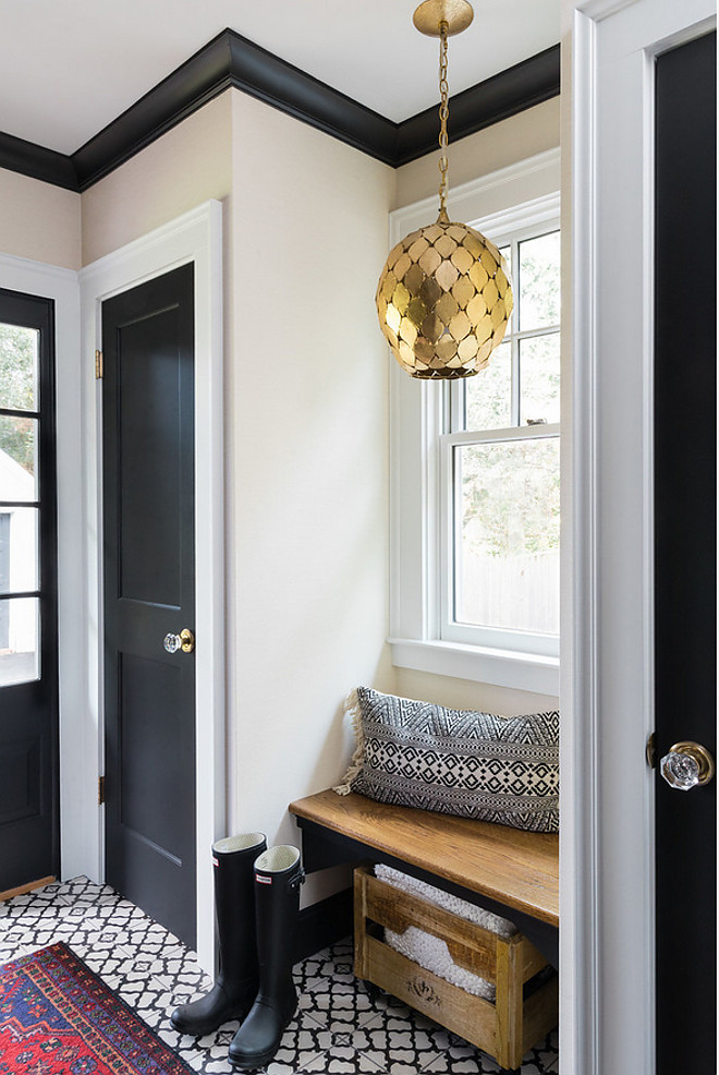 Farmhouse Mudroom with black door black trim black cabinet back and white cement tile farmhouse mudroom