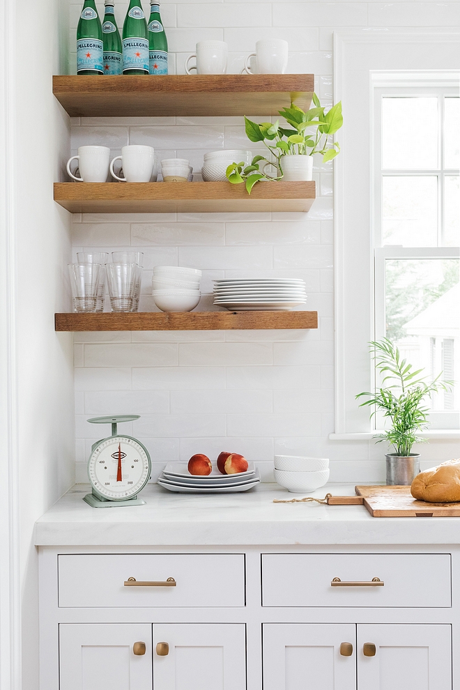 Kitchen with floating sheves over big subway tile backsplash and white marble countertop