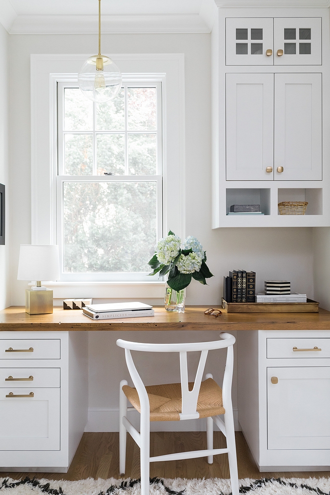 Built in desk with wood countertop and a white Wishbone Chair